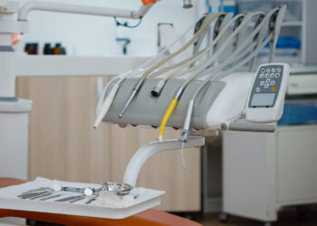 Close up of medical stomatology equipment in modern bright office, orthodontic drill and other professional dental health teethcare instruments. Dentistry cabinet with dental orthodontist tools